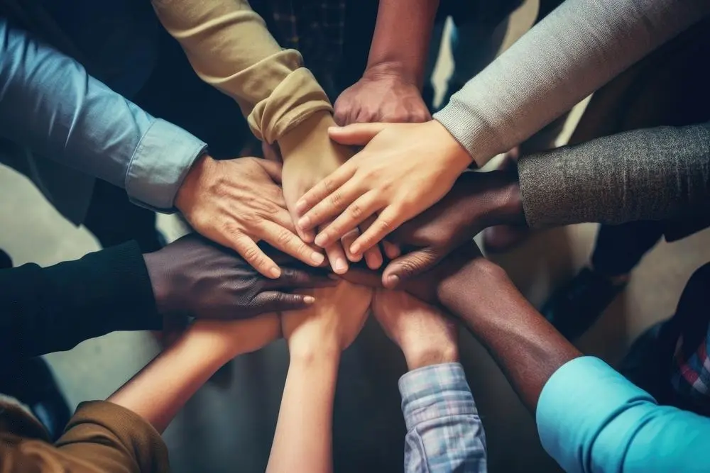 A group of people that are holding hands in the middle